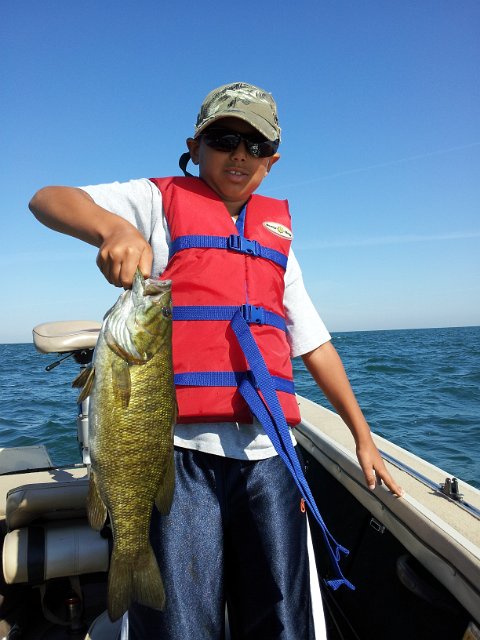 2012-07-30 09.42.47.jpg - Josh and a nice Lake Ontario Smallmouth from the Mouth of the Niagara River.